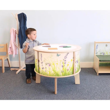 Nature view radiant LED light table side view with participant.